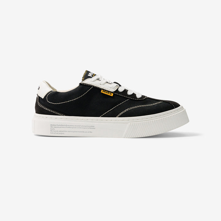 baskets en toile noire avec semelle blanche, style Vans