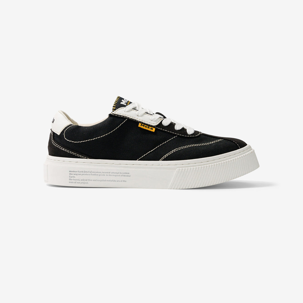 baskets en toile noire avec semelle blanche, style Vans