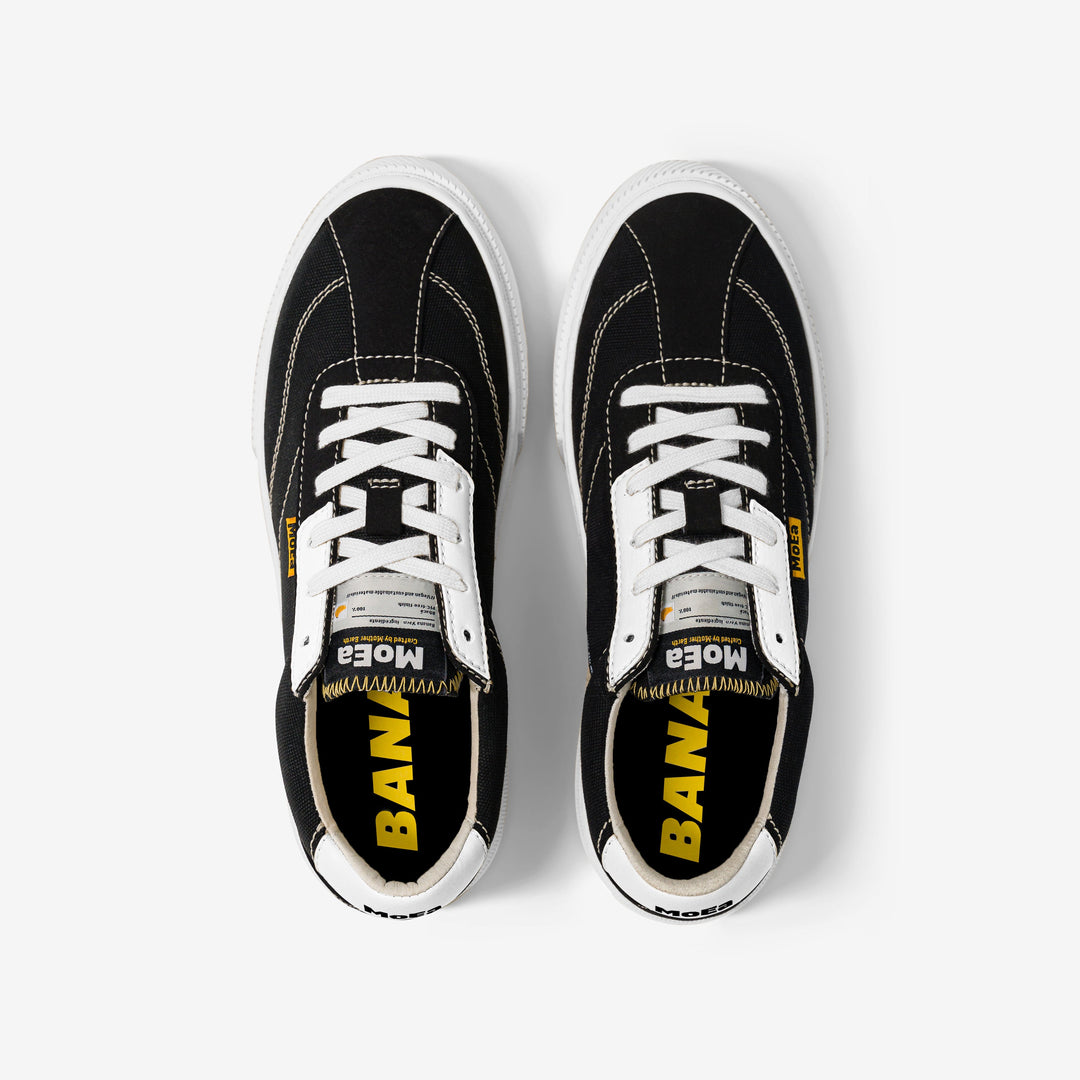 baskets en toile noire avec semelle blanche, style Vans