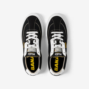 baskets en toile noire avec semelle blanche, style Vans