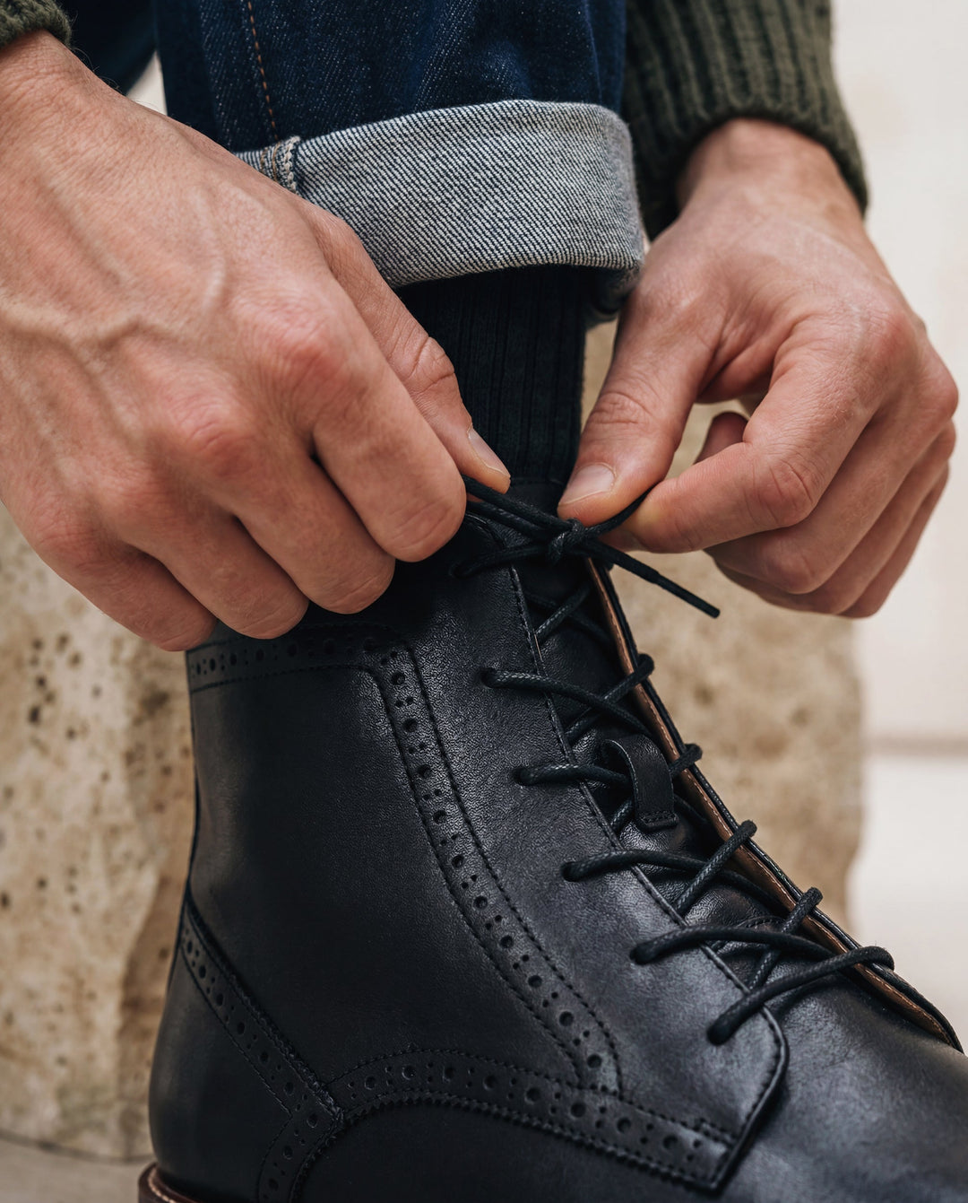 CHASE Black vegan brogue ankle boot styled on male model — men’s ethical dress boot in all-black, NAE Vegan Shoes, made in Portugal