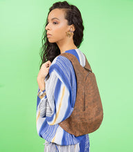 Load image into Gallery viewer, photo of the dark natural cork Arsayo backpack with a woman model