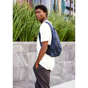 photo of the blue navy Arsayo backpack with a man model