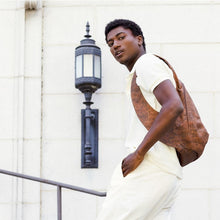 Load image into Gallery viewer, photo of the dark natural cork Arsayo backpack with a man model