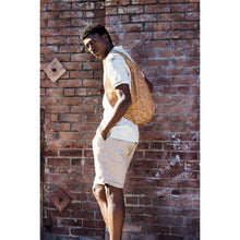 Load image into Gallery viewer, photo of the light natural cork Arsayo backpack with a man model